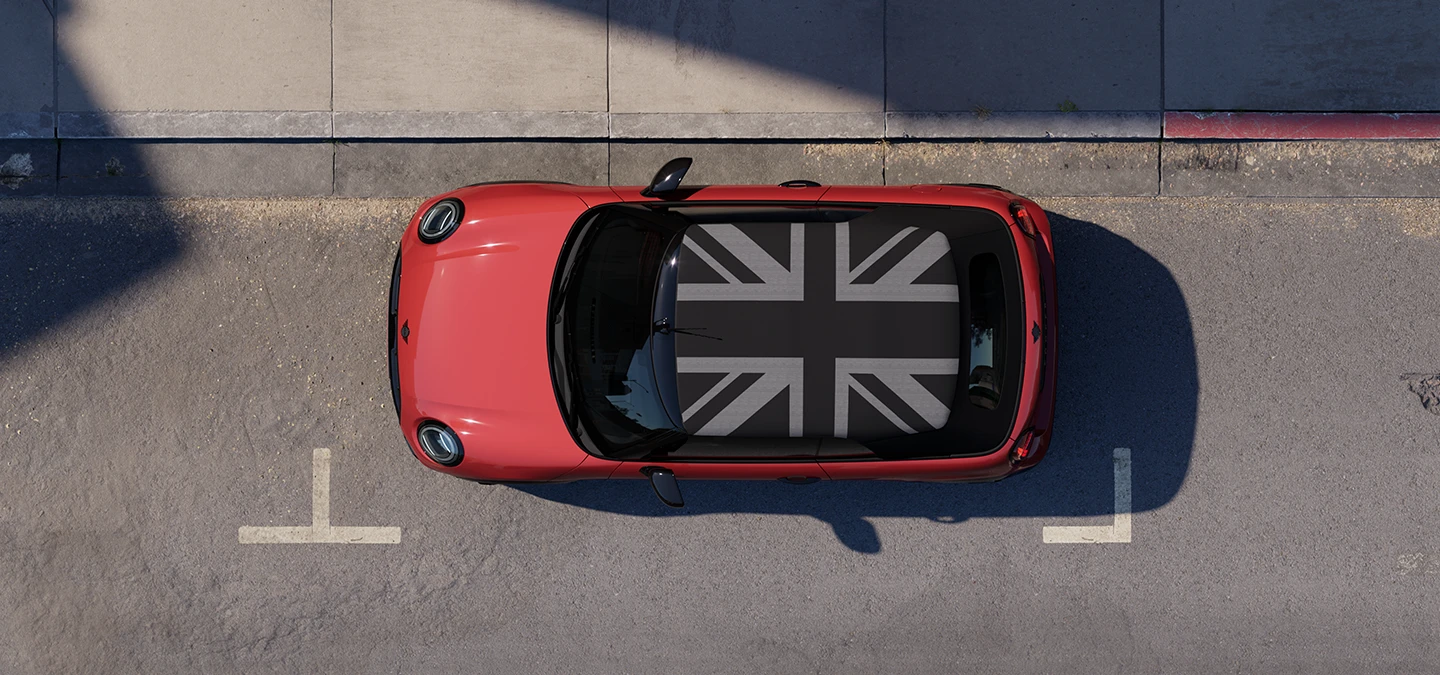 俯瞰Chili Red車色的MINI Cooper敞篷車搭配MINI專屬車頂，停靠在街道上。