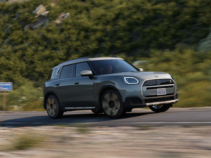 駕駛純電MINI Countryman（搭配Vibrant Silver車頂）的側面越野行駛畫面。